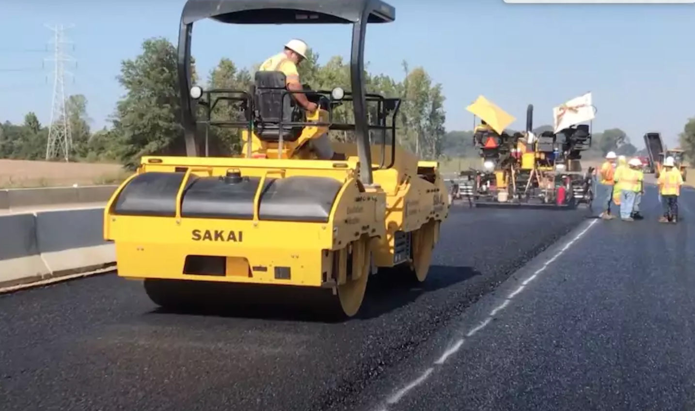 Sakai oscillating asphalt roller shown operating on a job site.