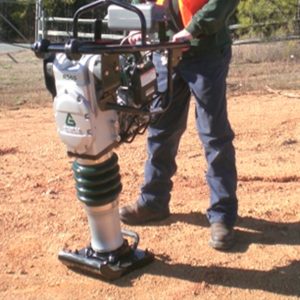 Construction working utilizing a Sakai RS65 rammer or jumping jack on a site prep job.