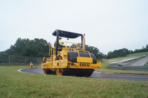 Sakai SW850ND oscillatory asphalt roller operating on a race track resurfacing job in Birmingham, Alabama, USA.