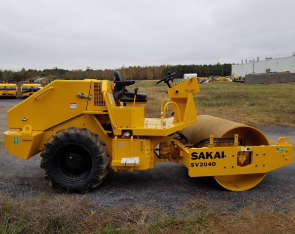 Sakai SV204D smooth drum vibratory soil roller with tractor lug tires and no ROPS installed.
