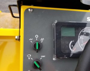 SV414T soil compactor dash panel showing vibration frequency control and push button vs continuous vibratory mode switch.