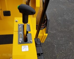 Close up of forward neutral reverse lever on the SV414 soil compactor operator deck.