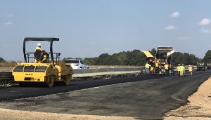 Sakai highway class oscillatory and vibratory asphalt rollers paving on a job site.