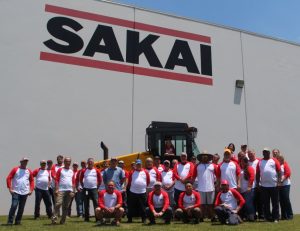 Sakai America manufacturing team and office staff celebrate the 20th anniversary of the plant in Adairsville, GA USA where asphalt rollers and soil compactors are built.