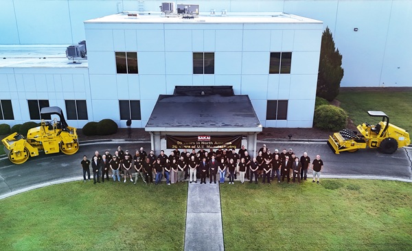 All SAKAI America employees pose for a drone photo with an asphalt roller and soil compactor outside the Georgia USA factory. Pictured in the center are SAKAI Heavy Industries global president Ichiro Sakai and son-in-law Chris Takara executive officer and general manager of the corporate strategy office.