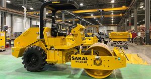 The first US built Sakai SV204 54 inch 5 ton smooth drum soil compactor sits in front of the Adairsville Georgia assembly line.