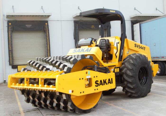 Sakai SV544T soil compactor with padfoot or sheeps foot drum and lug tires.