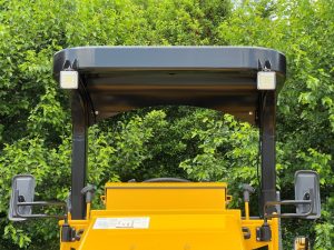Front view of the SW654 asphalt roller's ROPS showing brackets and LED work light assemblies.
