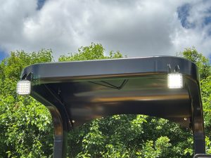 Front view of illuminated LED work lights during the day on a SAKAI SW654 asphalt roller.