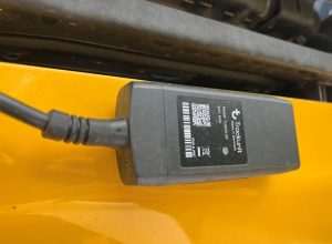A Track Unit telematics module mounted on a SAKAI asphalt roller.