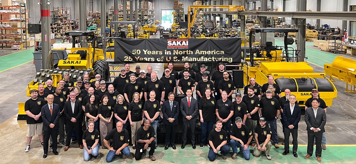 All SAKAI America employees post in front of the assembly line in Adairsville Georgia USA for their 50th anniversary in North America and 25th manufacturing anniversary. Shown with SAKAI global leadership Ichiro Sakai and Chris Takara.