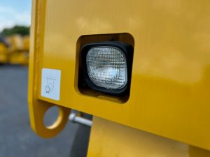 Close up of rear halogen light assembly on the SAKAI GW754 vibratory pneumatic tire roller or traffic roller.