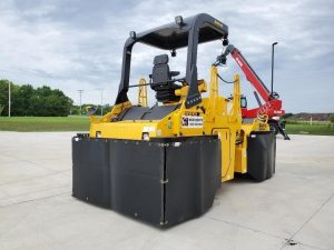 Optional heat retention skirts for the SAKAI GW754 pneumatic tire asphalt roller to prevent asphalt pickup on the mat. Rear view back right.