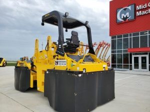 Optional heat retention skirts for the SAKAI GW754 pneumatic tire asphalt roller to prevent asphalt pickup on the mat. Rear view back left.