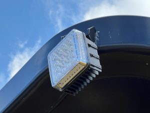 Close up of the optional LED work lights for the SAKAI GW754 vibratory pneumatic tire roller to illuminate the job site for night asphalt paving.