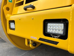 Upgraded front lights on a SAKAI R2H-4 3 wheel asphalt roller in lieu of halogen.