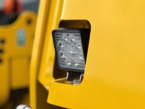 Upgraded LED front light assembly on a SAKAI SW354 or SW504 series asphalt roller.
