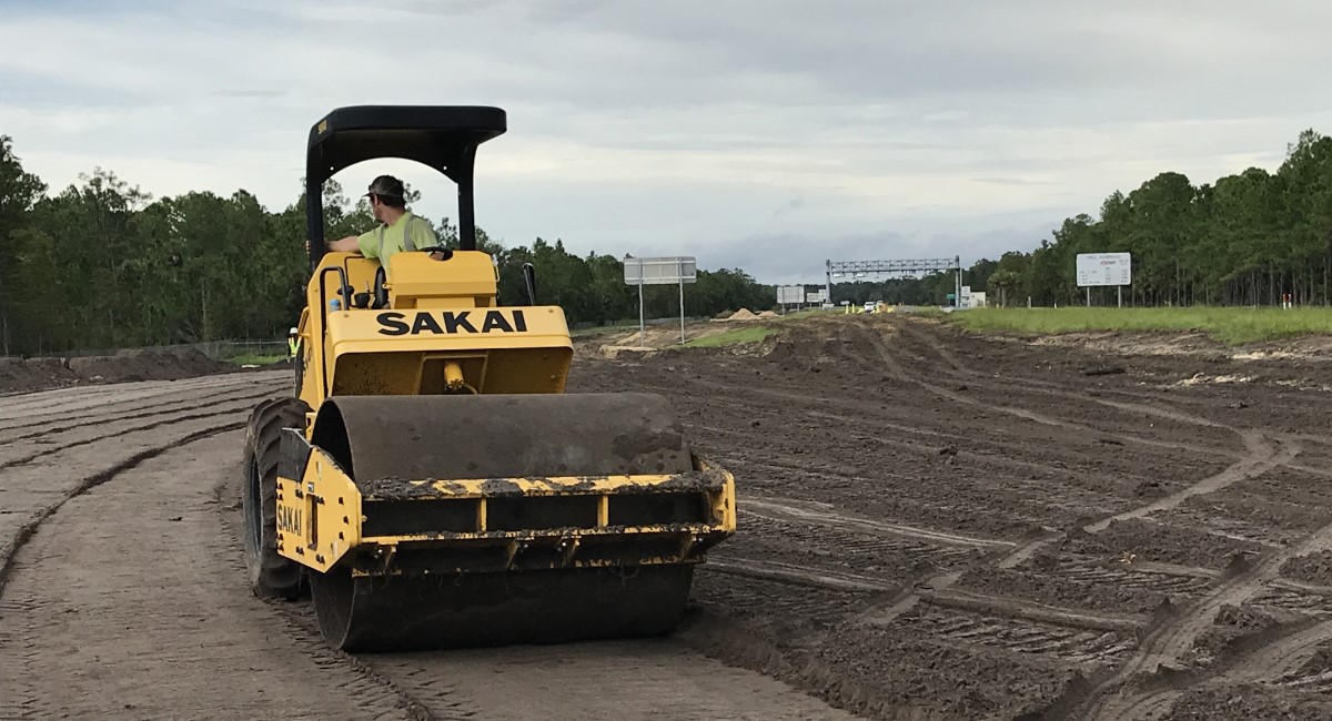 A newly developed SAKAI SV414ND oscillating soil compactor compacting on a job site in Florida.