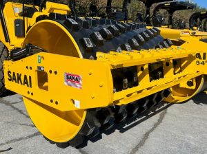 Padfoot or sheepsfoot shell kit over smooth drum on a SAKAI SV544 soil compactor.