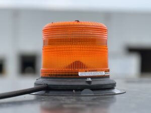 Optional magnetically mounted LED amber strobe or beacon shown on the ROPS of a SAKI asphalt roller.