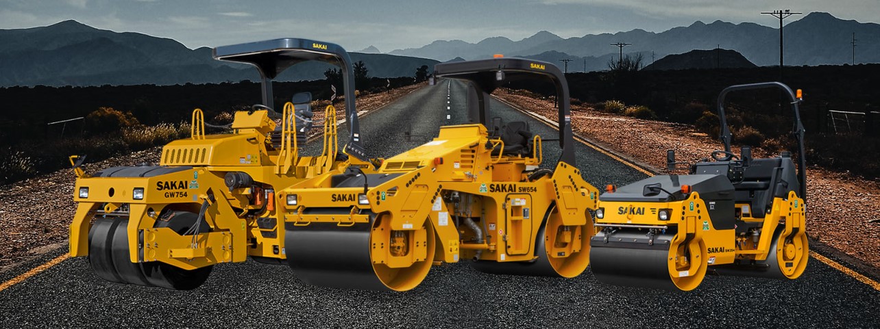 Sakai asphalt rollers on a freshly paved western US highway including the GW754 vibratory tire roller, SW654 58" double drum vibratory roller, and the SW354 47" double drum small asphalt roller.