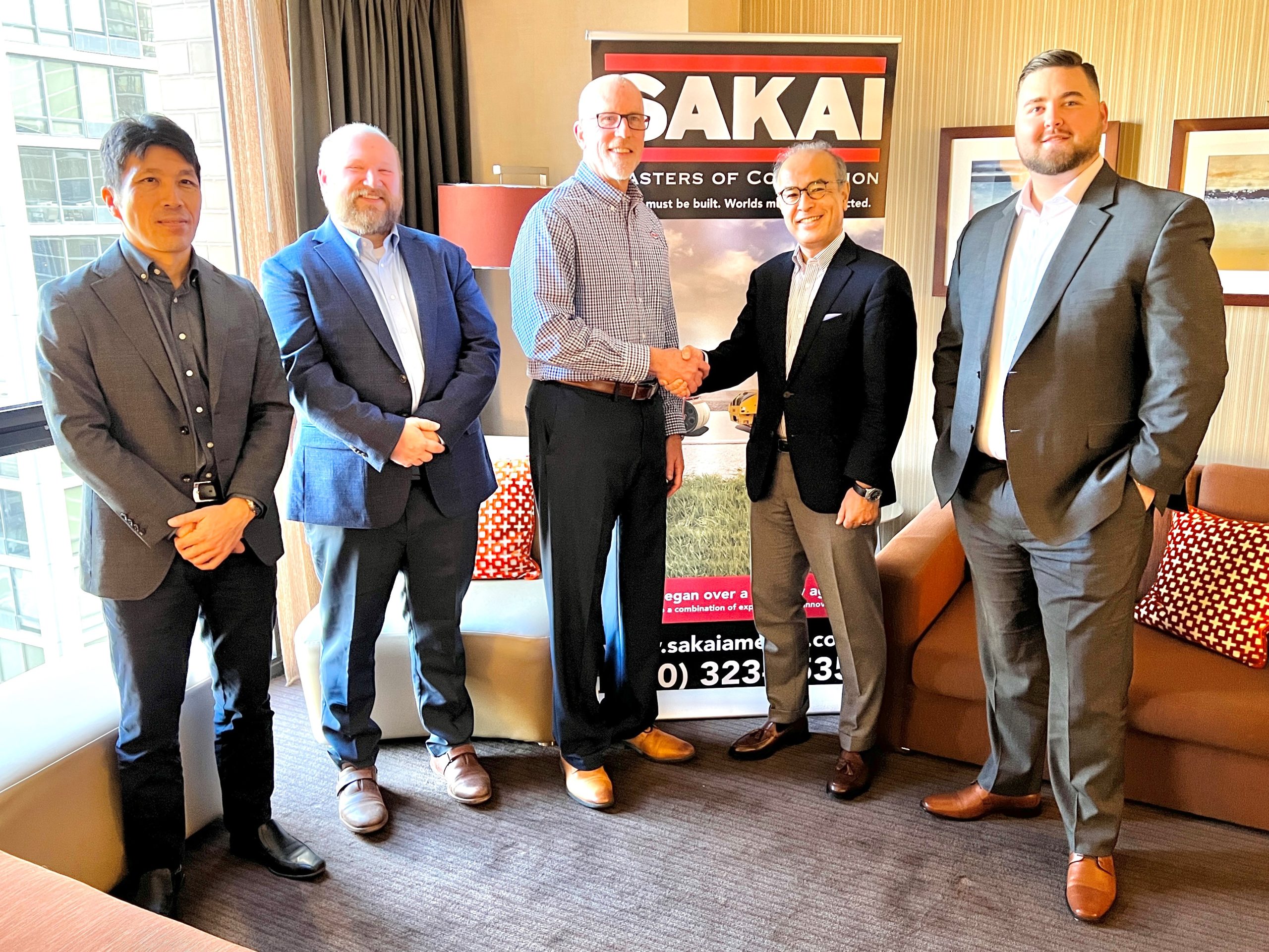 Sakai leadership with Taylor Construction Equipment leadership shaking hands to become a new asphalt roller and soil compactor dealer.