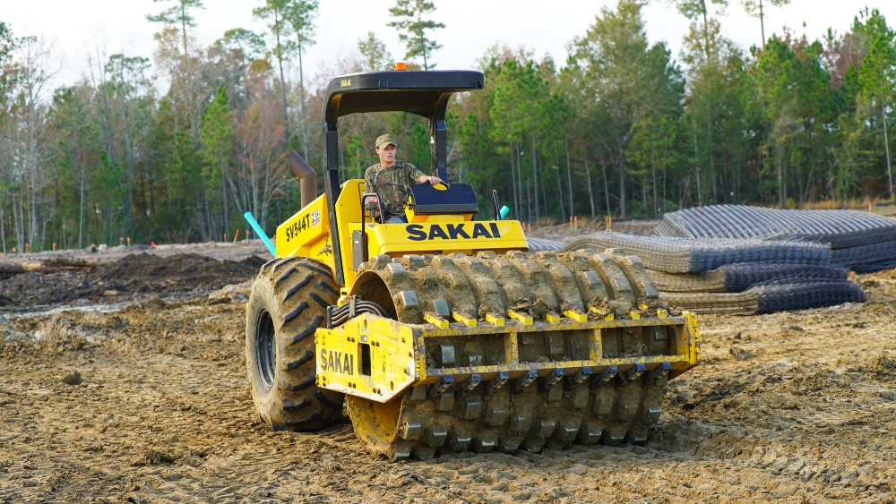 Sakai SV544T soil roller machine being used for sitework or earthwork on a job site in Savannah Georgia by contractor Tosky and company.